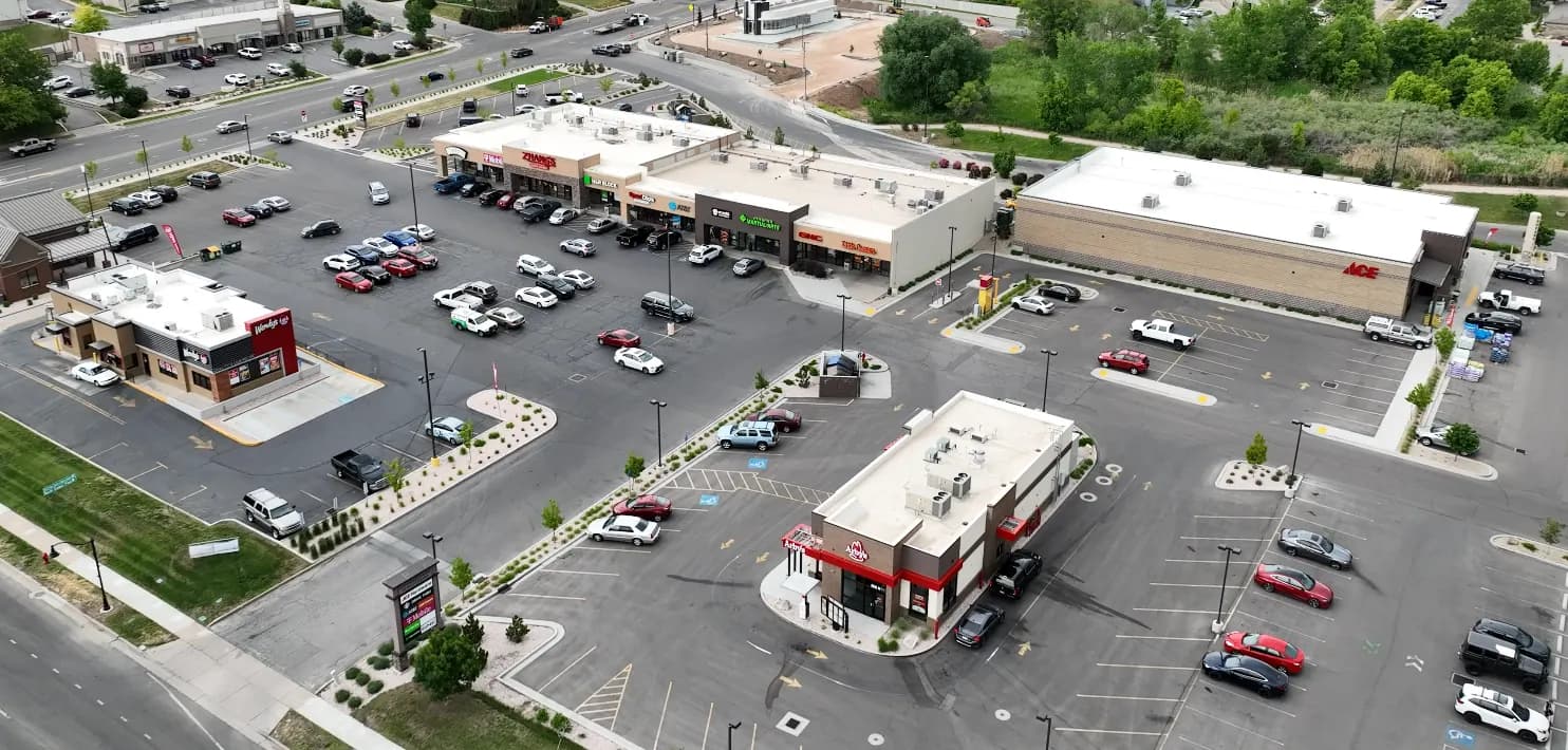 Aerial view of a northern Utah retail plaza with storefront businesses served by Low-Key Locksmith commercial lock and access control service